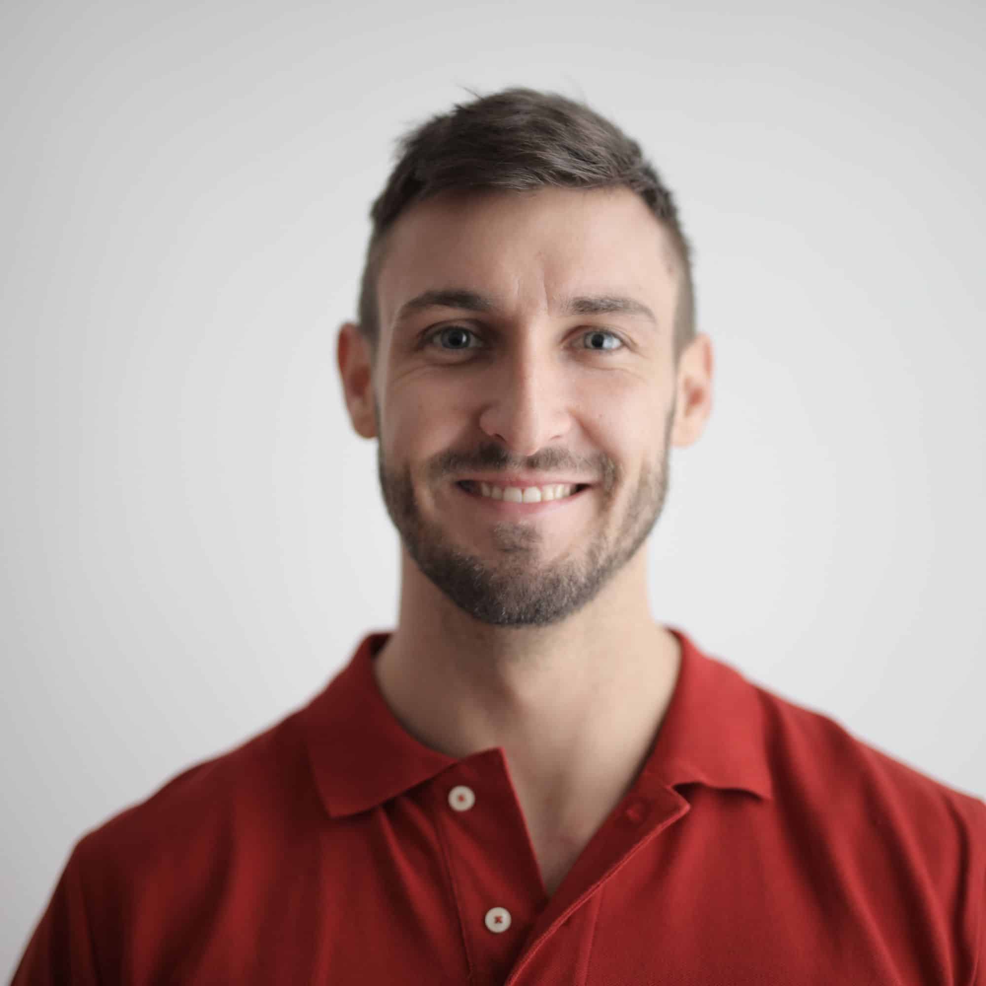 Professional headshot of man wearing red shirt working with data visualization